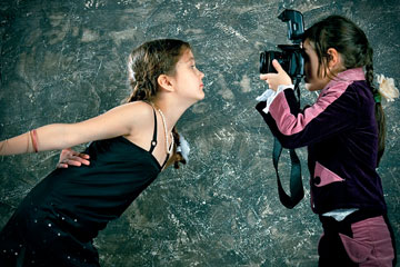 a young photographer photographing a child