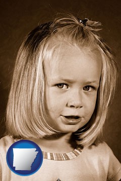 a sepia portrait of a female child - with Arkansas icon