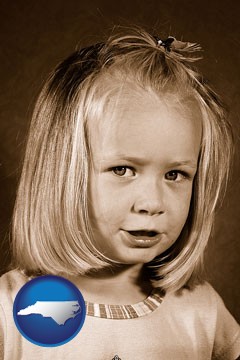 a sepia portrait of a female child - with North Carolina icon