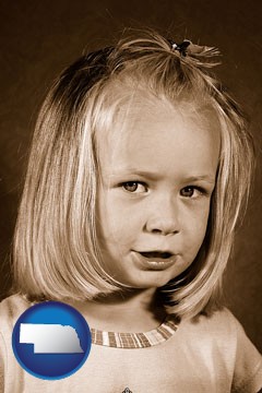 a sepia portrait of a female child - with Nebraska icon