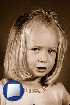 a sepia portrait of a female child - with New Mexico icon